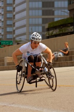 Female In Racing Wheelchair Works Out Along Chicago Asphalt clipart