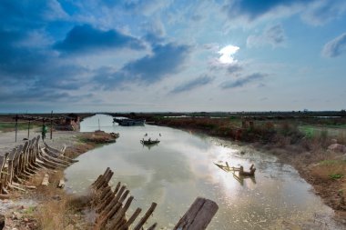 Discarded wooden boats and blue sky clipart