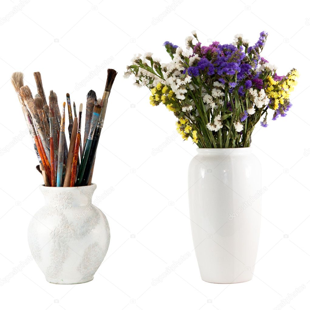 Jug with brushes and vase of wild flowers