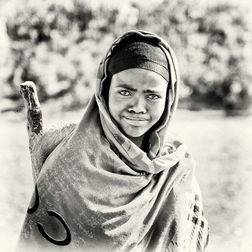 An Ethiopian woman watches straight and smiles to the camera – Stock ...