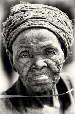 A very old lady from Benin poses for the camera clipart