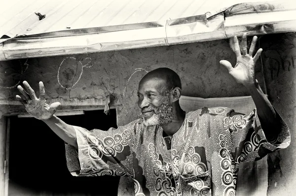 stock image A Benin old man smiles and waves his hands