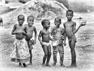 Group of Benin children eat and pose for the camera clipart