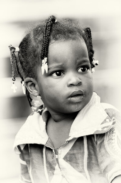 Little baby girl from Benin watches attentively