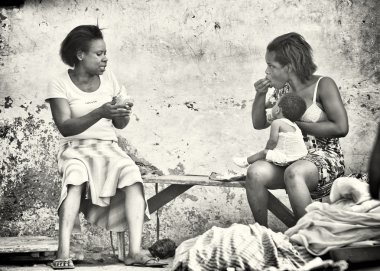 Two Ghanaian ladies eat and discuss something clipart