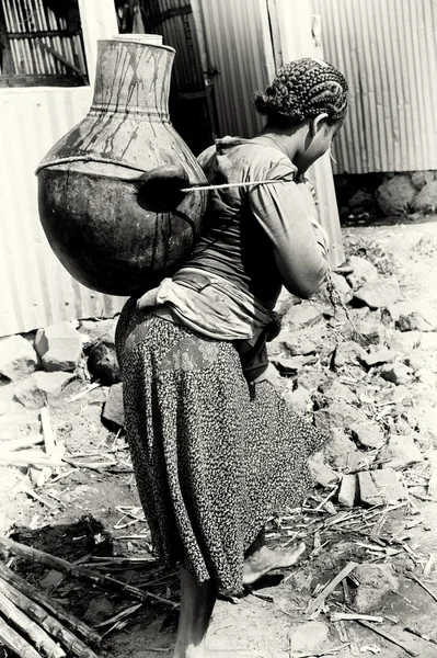 Uma mulher etíope com um jarro de água nas costas — Fotografia de Stock