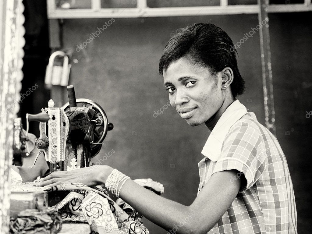 A Ghanaian woman sews using the sewing machine Stock Editorial Photo