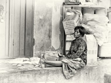 A Ghanaian woman sits and thinks of life clipart