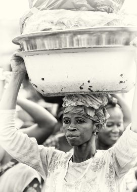 A Ghanaian lady with basin of clothes clipart