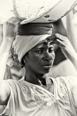 A young Ghanaian woman with a basin