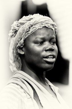 A Ghanaian woman with white tissue poses for the camera clipart