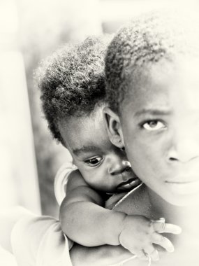 Little baby boy from Ghana on the shoulder of his brother clipart