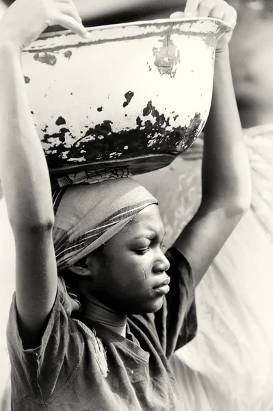 Una mujer de Ghana con una cuenca en la cabeza —  Fotos de Stock