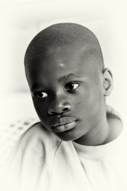 A beautifull Ghanaian boy in front of the camera clipart