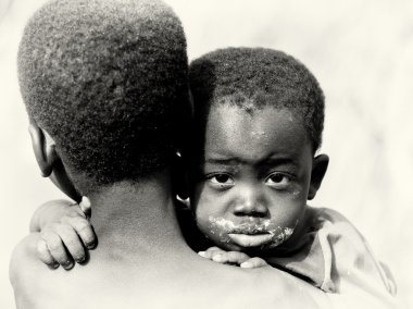 A Ghanaian baby boy hugs his brother clipart