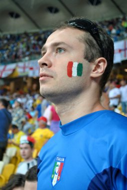 A fan of the national Italian football team sings the anthem clipart