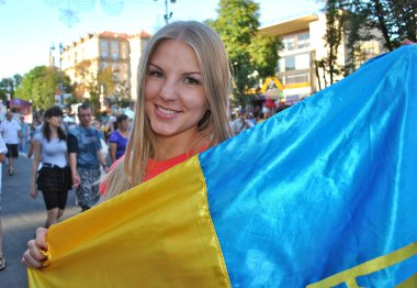 Beautiful Ukrainian football fan with national flag