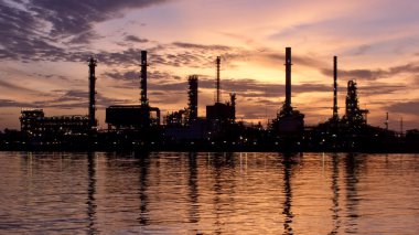 Lonely, Sunrise, oil refinery factory with reflection on the river. clipart