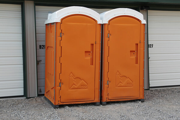 Two orange Porta Pottys