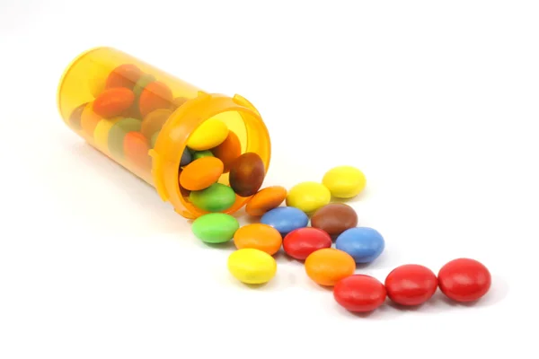 Candy spilling out of pill bottle — Stock Photo, Image
