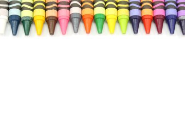 Border of crayons in array of colors. clipart