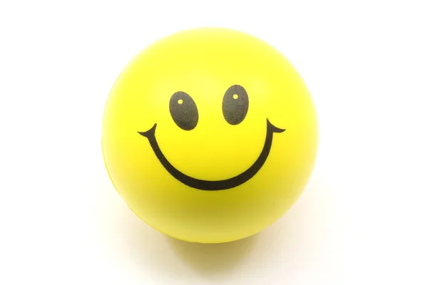 Gele smiley gezicht stressbal — Stockfoto