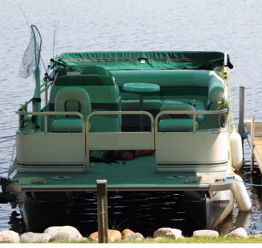 Pontoon Boat docked at Pier clipart