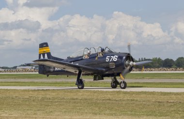 Blue Navy Fighter starting down runway clipart