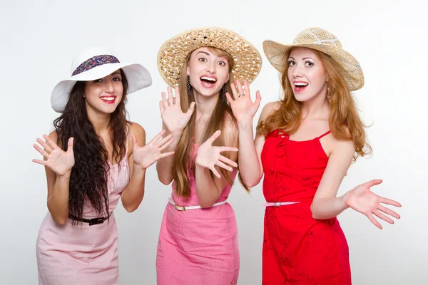 Three happy female friends on white background — Stock Photo, Image