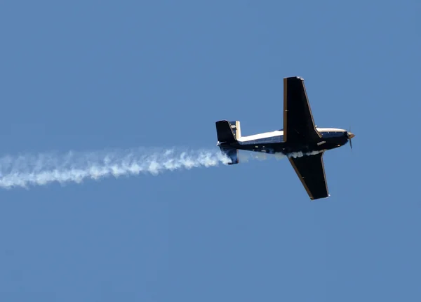 Airplane with smoke trail — Stock Photo, Image