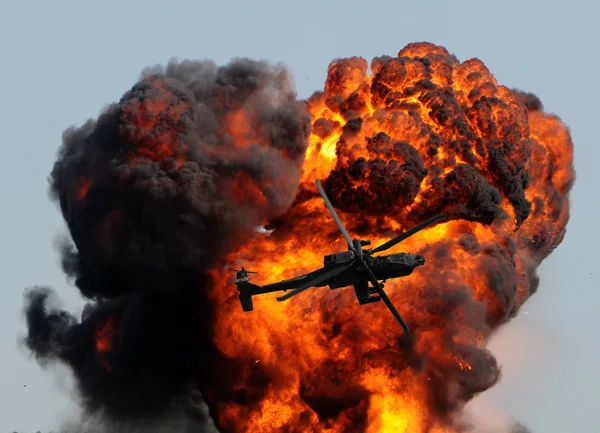Helicopter and giant explosion — Stock Photo, Image