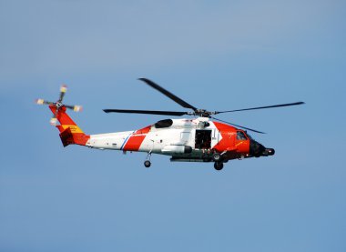 Us Coast Guard Helicopter Departs On Patrol clipart