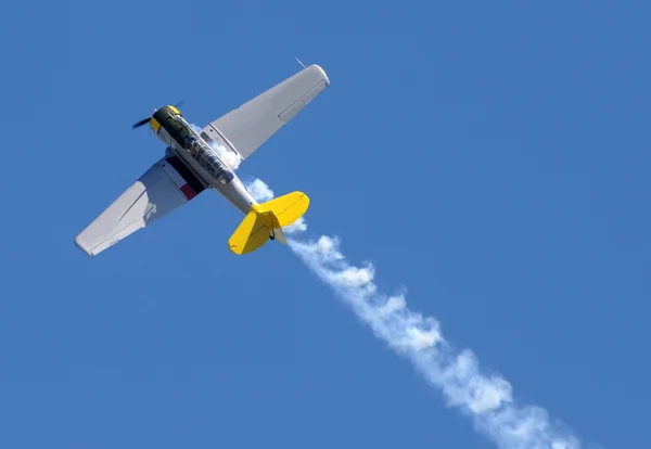 Propeller airplane with smoke — Stock Photo, Image