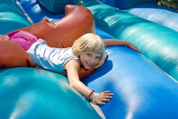 Girl playing on an inflatable toy — Stock Photo, Image