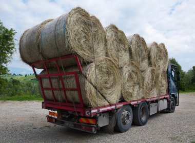 Bundles of hay on the lorry clipart