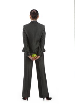 Business woman turned away, behind a green apple clipart