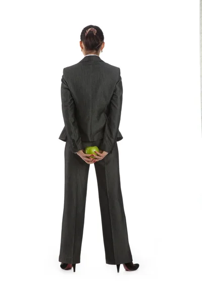 stock image Business woman turned away, behind a green apple