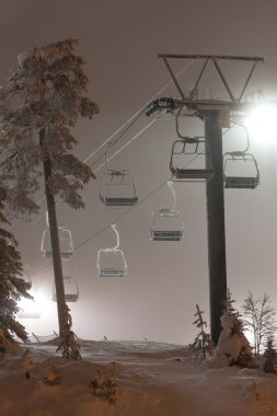 Ski resort elevators at night clipart