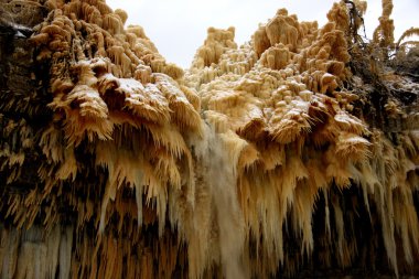 Partly frozen waterfall in Eastern Estonia clipart