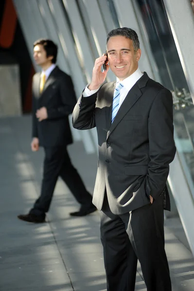 Un om de afaceri care zâmbește la telefon — Fotografie, imagine de stoc