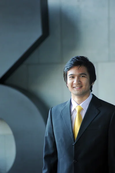 Азіатський Ділова людина, одягнений у костюм і краватку, посміхаючись. — стокове фото