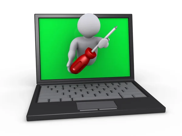 Persona con destornillador a través de laptop — Foto de Stock