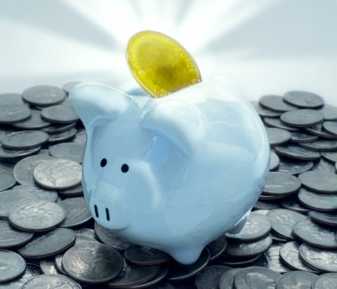 Shiny Piggy Bank With Glowing Gold Coin On Pile Of Quarters clipart