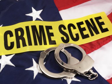 Crime Scene Tape And Hand Cuffs Over American Flag clipart