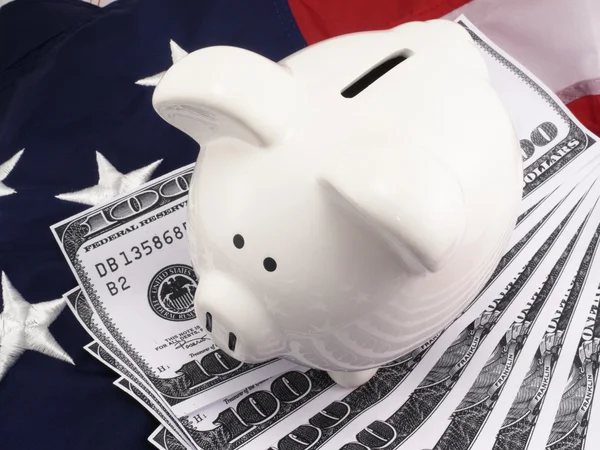 stock image Piggy Bank Over American Flag And 100 Dollar Bills