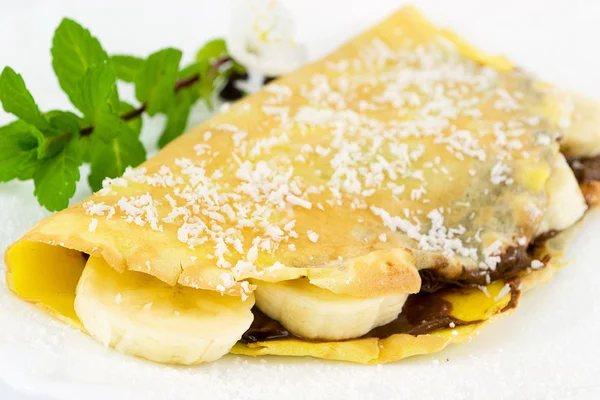 Crepes filled with chocolate, banana and coconut — Stock Photo, Image