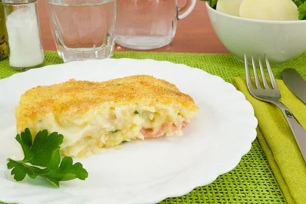 Piece of cake baked potatoes with ham and cheese — Stock Photo, Image