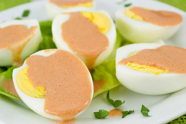 Boiled eggs served with cocktail sauce — Stock Photo, Image