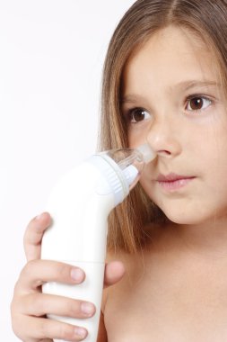 Child with nasal aspirator clipart
