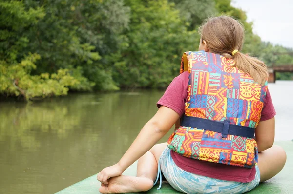 stock image Little girl sitting in front of the boat